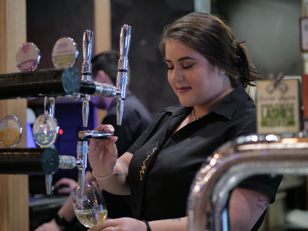 Image of staff member pulling a beer